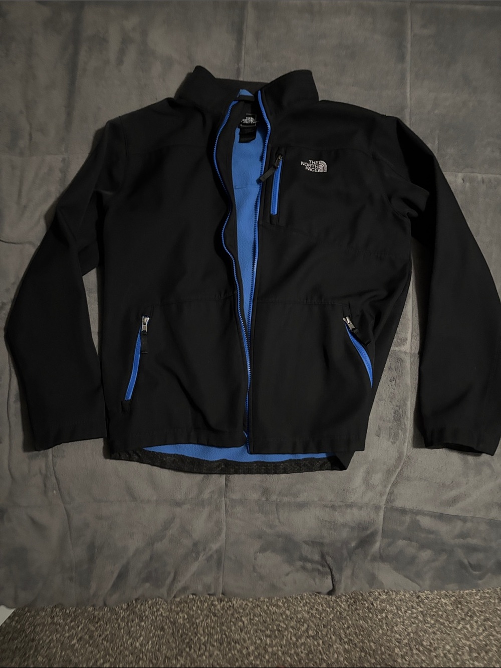 The North Face Kid’s Black Windbreaker Jacket with Blue Accents